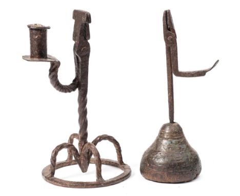 A 17th century wrought iron rush light holder: with hinged scissor action and candlestick holder on a spiral twist stem, on f
