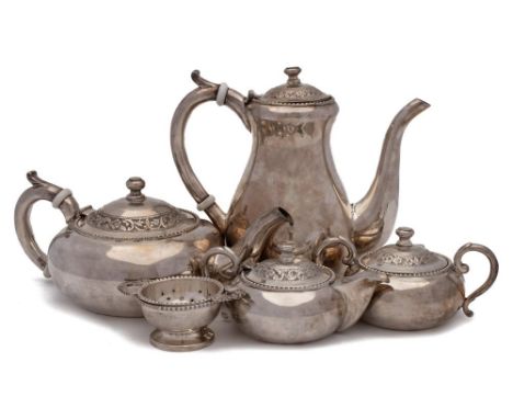 An Indian silver five piece tea & coffee service: the coffee and teapot with ceramic insulators to the handles, sugar basin, 