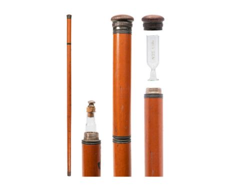 A malacca walking/tipple stick: the screw turn handle enclosing a clear glass phial etched 'Big Ben', the screw top pommel en