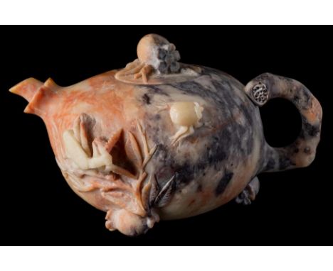A Chinese carved soapstone teapot and cover: in the form of a pomegranate with stalk handle, the sides with foliage and insec