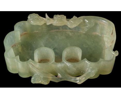 A Chinese carved nephrite brush washer: of scroll form, the rim carved with a chilong and lingzhi, 11 x 8 cm.