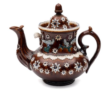 A Measham 'bargeware' teapot: with domed cover and acorn knop, the body sprigged with flower heads, birds in branches and a f