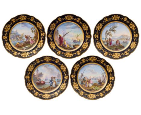 A set of five French porcelain plates: in the Sèvres manner, the centres painted with extensive estuary and river views with 