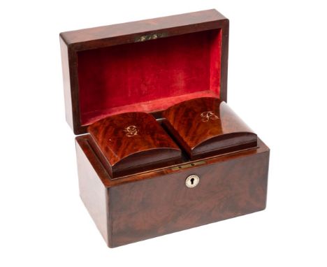 A Georgian mahogany tea caddy: of plain rectangular form, the hinged lid enclosing a pair of lidded canisters, 27cm. wide.
