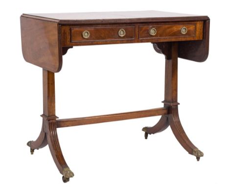 A mahogany sofa table in the Regency taste:, the hinged top with rounded corners and a reeded edge, on standard column and fl