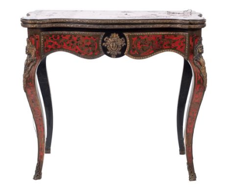 A 19th Century French ebonised and gilt metal mounted card table:, of serpentine outline, veneered in scarlet tortoiseshell a