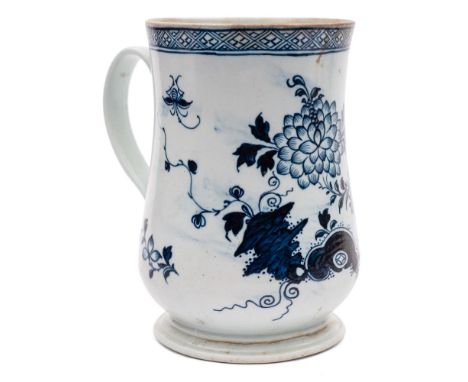 A large Liverpool [Richard Chaffers] blue and white bell-shaped mug: painted with pierced rockwork, a large moth, chrysanthem