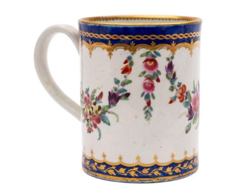 A First Period Worcester cylindrical mug: with grooved strap handle, painted with pendant floral swags within gilded bright b
