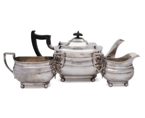 A George VI silver three piece tea service, maker William Hutton &amp; Sons Ltd, Sheffield, 1942: the teapot of barge shaped 