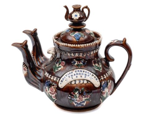 A Measham 'bargeware' double spouted teapot: with domed cover and teapot knop, the body sprigged with bouquets and a panel im