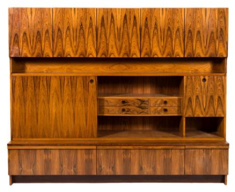 An Archie Shine Ltd 'Bridford' teak and rosewood storage unit circa 1975:, the upper section of five flame panelled doors ove