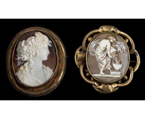 A large oval shell carved portrait cameo brooch within a gilt frame, depicting a classical woman: her hair adorned with folia