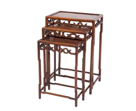 A nest of three Chinese Hua Li wood rectangular occasional tables:, with pierced scroll aprons on shaped and turned supports,