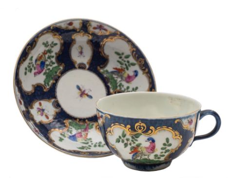 A First Period Worcester blue scale coffee cup and saucer: painted with gilt rococo cartouches of exotic birds and insects on