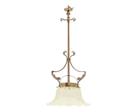 An Art Nouveau period brass central ceiling light: the central stem with curved and swept stylised supports retaining a yello