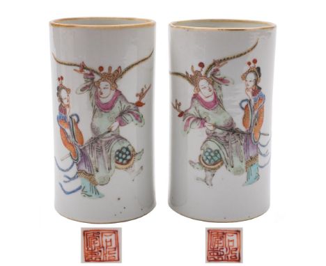 A pair of Chinese famille rose cylindrical vases: each painted with two figures from a scene from the Wu Shang Pu 'Table of P