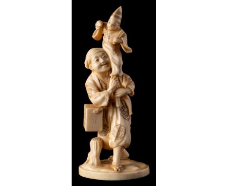 A Japanese carved ivory okimono of a Puppeteer, signed Gyokushi: holding a puppet above his head, Meiji Period, 13.5cm high.