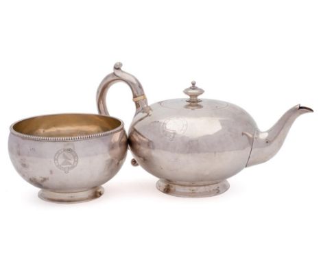 A Victorian silver plain circular teapot and a matching sugar basin, maker Alexander Macrae, London, 1864: crested, of plain 