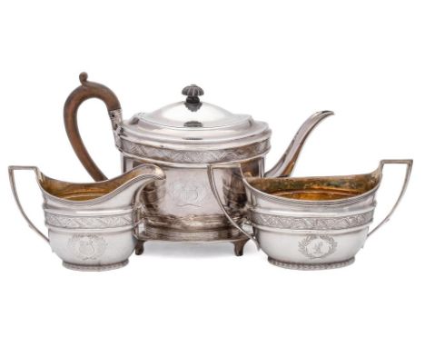 A George III three-piece tea service and a matching teapot stand, maker John Emes, London, 1801: crested, of oval outline wit