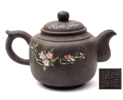 A Chinese Yixing teapot and cover: enamelled with peaches and blossom, potter's seal mark, 19th/20th century, 11 cm high.