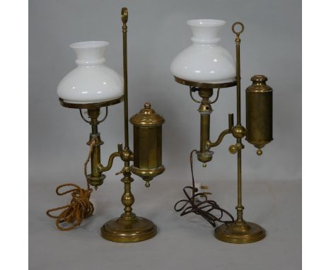 C.A. Kleemann New York, a pair of vintage brass electric student's lamps with faux oil reservoirs and white glass shades. Mar