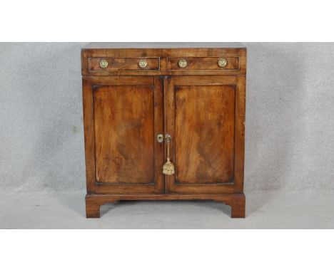 A late Georgian figured mahogany side cabinet with caddy top above a pair of drawers and panel doors on bracket feet. H.85 W.