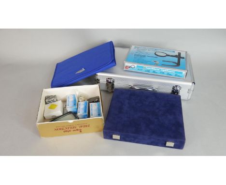 A collection of various coin collectors tools and storage cases. Including capsules, wallets, various lopes and magnifiers, c