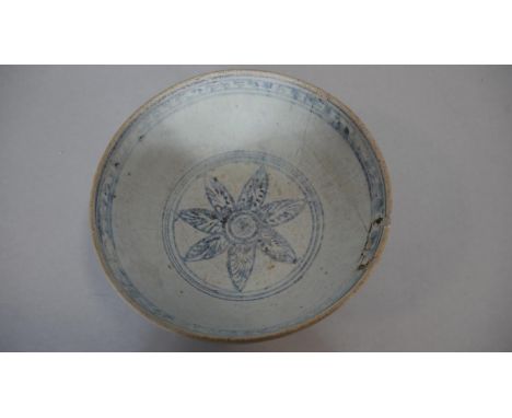 An Oriental blue and white ceramic glazed bowl with floral motif to the inside centre and stylised blue glaze design to the o
