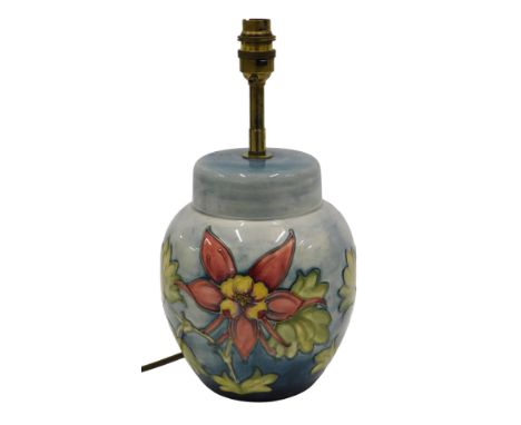 A Moorcroft ceramic lamp base, modelled in the form of a ginger jar, decorated with red and yellow flowers with leaves, on a 