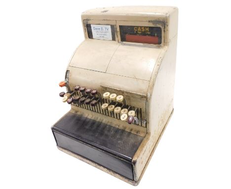 A vintage beige painted cash register. (AF)