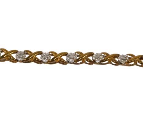 A tennis bracelet, set with tiny white stones, on cross and dot decoration, white metal stamped 925, with gold finish, 19cm l