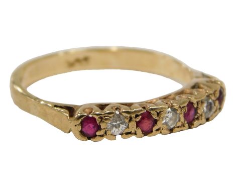 A ruby and diamond dress ring, set with seven stones, in claw setting, on a yellow metal band, stamped 9ct, ring size R½, 2.6