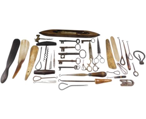 A quantity of corkscrews, vintage keys, shoe horns, candle snuffers, etc.
