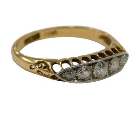 An Art Deco diamond dress ring, set with five old cut diamonds in platinum, on a yellow metal scroll and pierced band, ring s