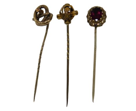 Three stick pins, each gold plated, one stone set.