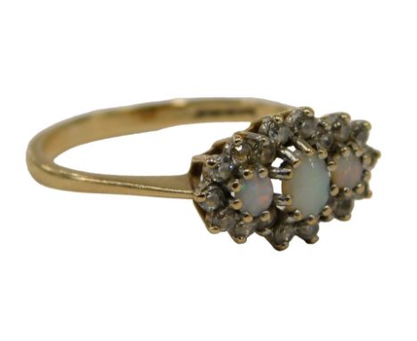 A 9ct gold cluster ring, set with three opals, one oval, two round brilliant cut, surrounded by round brilliant cut tiny diam