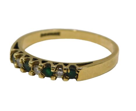 An 18ct gold emerald and diamond half hoop dress ring, set with seven round brilliant cut stones, each claw set, ring size P,