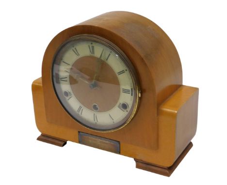 An Andrew teak mantel clock, with a silvered Roman numeric dial, with presentation plaque dated 1957, 22cm high, 26cm wide, 8