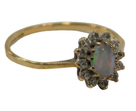 A 9ct gold cluster ring, set with oval opal, surrounded by CZ stones, in claw setting with V splayed shoulders, ring size L½,