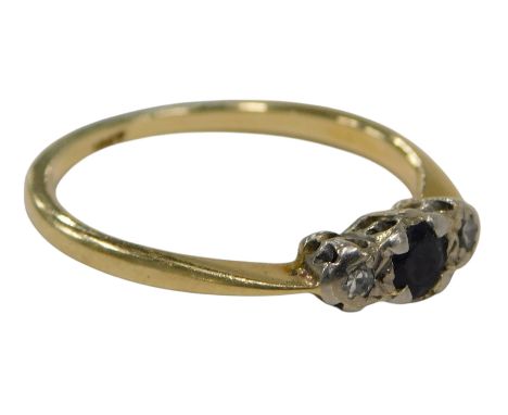 A sapphire and diamond dress ring, set with central sapphire, flanked by two tiny diamonds, on yellow metal band, marked 18ct