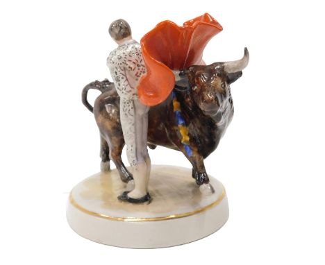 A Studio ceramic figure of a Spanish bull fighter, with bull, on oval base, impressed marks to underside, 10cm high.