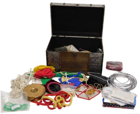 A large quantity of magician's magic tricks, etc., in wood and silver coloured metal trunk.
