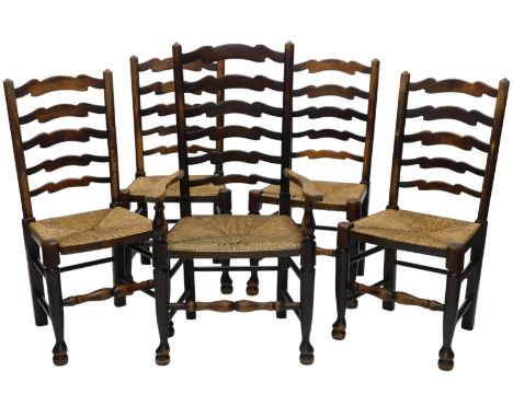 A set of five oak ladder back dining chairs, each with a rush seat, on turned supports with pad feet, 159cm wide overall.