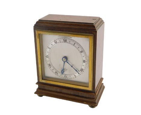 An Elliott mantel clock, in mahogany case, with silvered chapter ring and Roman numerals, 15.5cm high, with instructions.