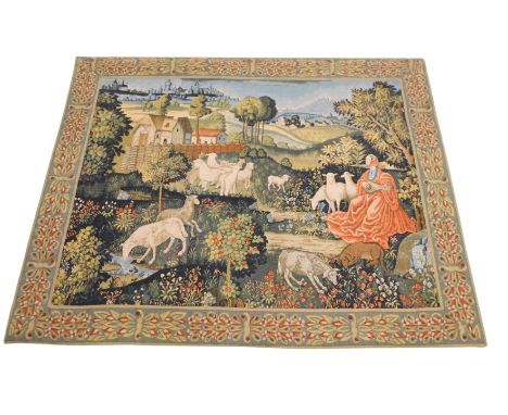 An Aubusson style tapestry, Concert Champetre, depicting lady playing loot beside sheep, buildings with towns and villages in