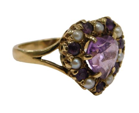 A 9ct gold amethyst and seed pearl Edwardian dress ring, the central heart cut amethyst in claw setting surrounded by tiny am