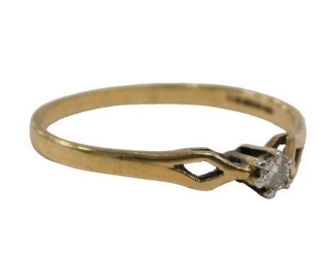 A 9ct gold diamond solitaire ring, set with round brilliant cut tiny diamond, approx. 0.05ct, claw set, with a raised shank, 