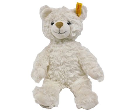 A Steiff white plush teddy bear, with button and tag to ear, 28cm high.