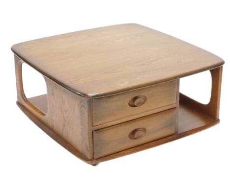 A vintage Ercol Pandora coffee table, the square top with rounded ends, above an arrangement of drawers and recessed with cas