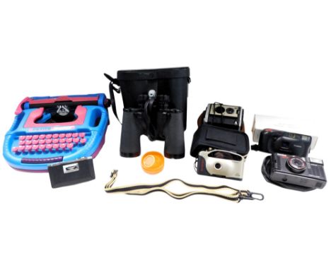 A Petite 380 child's typewriter, various cameras, and a pair of Tecnar Swift 12x50 binoculars.